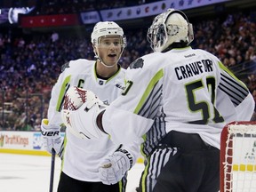 Jonathan Toews #19 of the Chicago Blackhawks and Team Toews talks with Corey Crawford #50 of the Chicago Blackhawks and Team Toews during the 2015 Honda NHL All-Star Game at Nationwide Arena on January 25, 2015 in Columbus, Ohio. (Gregory Shamus/Getty Images/AFP)