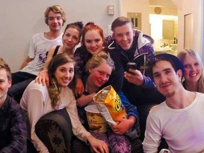Julie Abrahamsen (pictured in the middle. holding a bag of chips) with her friends after being lost for three days. 

Facebook/Sierra Niecke