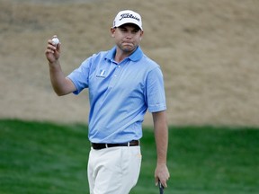 American Bill Haas salutes the gallery upon making his putt on the 16th hole during the final round of the Humana Challenge on Sunday in California. Haas notched a single-stroke victory.