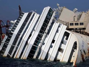 The capsized cruise liner Costa Concordia lies surrounded by containers called "sponsons" as part of the salvage plan to remove the wreck of the ship outside Giglio harbour August 8, 2013.    REUTERS/Stefano Rellandini