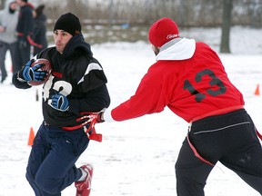 Jesse Gross of the Dirty Birds team runs past a defender during the Nippilus Erectus flag football tournament held at Dauw Park on Saturday, January 24, 2015. The Dirty Birds went on to win the championship. Seven teams from across Chatham-Kent took part in the annual tournament.