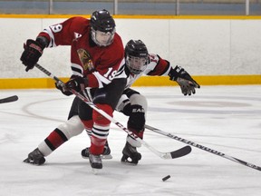 Defenceman Jordan MacKenzie (19) of the Mitchell Hawks outraces Walkerton’s Alex Perrault (14) for the puck during Western Jr. C action last Saturday in Mitchell, a 5-3 loss. ANDY BADER/MITCHELL ADVOCATE