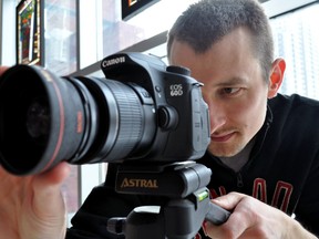Filmmaker Mark Drewe peers into a camera at Covent Garden Market in London Ont. Jan 23, 2015. CHRIS MONTANINI\LONDONER\QMI AGENCY
