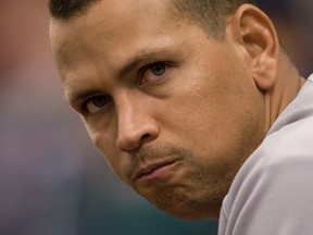 New York Yankees' Alex Rodriguez watches from the dugout railing during the 11th inning of their MLB American League baseball game against the Tampa Bay Rays in St. Petersburg, Florida, in this August 25, 2013 file photo. (REUTERS/Steve Nesius/Files)