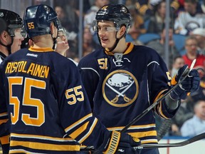 Nikita Zadorov and Rasmus Ristolainen of the Buffalo Sabres talk to officials during a break in play against the Calgary Flames at First Niagara Center on December 11, 2014. (Jen Fuller/Getty Images/AFP)