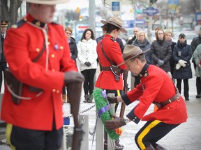 RCMP Supt. Marlon Dawaskiba lays a wreath at the RCMP Cenotaph in Winnipeg on Monday during a memorial for Cst. David Wynn, who was killed in the line of duty in Alberta earlier this month. (Brian Donogh/Winnipeg Sun)