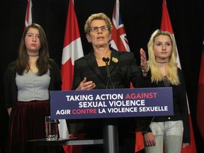 Premier Kathleen Wynne, with Toronto students Tessa Hull (left) and Lia Valente, announces that the new sex education curriculum will address the issue of consent Monday, Jan. 26, 2015. (Toronto Sun/Antonella Artuso)
