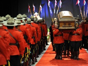 The casket leaves the funeral services for Royal Canadian Mounted Police (RCMP) Constable David Wynn in St. Albert, Alberta January 26, 2015. Wynn and Auxiliary Constable Derek Walter Bond were shot on January 17 while investigating a stolen vehicle. Wynn succumbed to the gunshot wound on Wednesday and Bond had been released after treatment.  REUTERS/Dan Riedlhuber