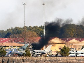 Smoke rises after a Greek F-16 fighter plane crashed during NATO training at the Albacete air base in Albacete, Spain, Jan. 26, 2015. (L. DE MIGUEL/Reuters)
