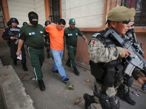 State police officers escort Clemente Martinez, who is arrested in connection with the murder of journalist Moises Sanchez, out of a court house in Veracruz January 26, 2015. Mexican prosecutors are investigating a small-town mayor in connection with the murder of a journalist in the Mexican Gulf coast state of Veracruz, whose brutalized body was found over the weekend, a state official said on Monday. A local drug gang member, confessed to kidnapping and killing journalist Sanchez, in league with five accomplices, Veracruz state prosecutor Luis Bravo said. The accused said he was given orders by a local police official and the bodyguard of Medellin de Bravo Mayor Omar Cruz. REUTERS/Yahir Ceballos