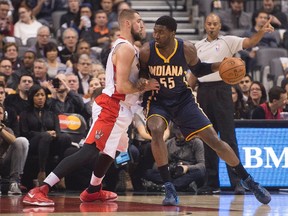 Indiana Pacers centre Roy Hibbert drives to the basket as Toronto Raptors centre Jonas Valanciunas tries to defend during the first quarter in a game at Air Canada Centre on Dec 12, 2014. (NICK TURCHIARO/USA TODAY Sports)
