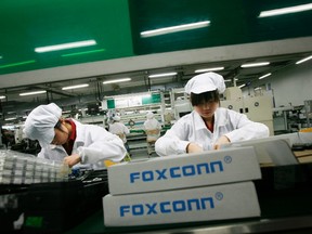 Employees work inside a Foxconn factory in the township of Longhua in the southern Guangdong province in this May 26, 2010 file photo.  REUTERS/Bobby Yip/Files
