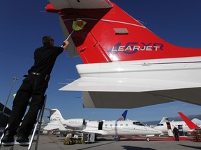 A worker cleans the tail of a Bombardier Learjet aircraft before the opening of the Annual European Business Aviation Convention & Exhibition at Cointrin airport in Geneva, in this file photo taken May 17, 2011.   REUTERS/Denis Balibouse/Files