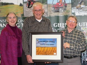 Shirley and Harry Buurma are this year's recipients of the Lambton County Outstanding Farmer of the Year Award. The annual award, which is hosted jointly by the Lambton County Soil and Crop Improvement Association, Parkland Farms and the St. Clair Region Consveration Authority, is presented each year to a farmer who has demonstrated conservation farming practices. From left is Shirley and Harry Buurma receiving the award from LSCIA director Fraser Hodgson.