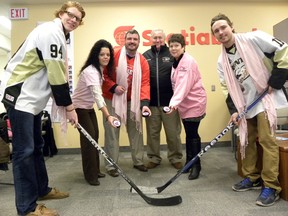 Ernst Kuglin/The Intelligencer
Trenton Golden Hawks Brady Wiffen and team Captain Tyler Donaldson face-off for the Feb. 13 Pink in the Rink Canadian Cancer Society hockey game fundraiser to be played at the Community Gardens in Trenton. Dropping the puck are Lianne O'Hara and Tina Furmidge, representing Scotiabank branches in Trenton and Golden Hawks president John McDonald.