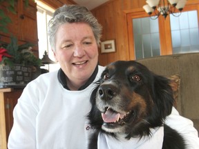 Cindy Berry sits with her pet therapy dog Tohe. The two are regular visitors to the intensive care unit at Kingston General Hospital, where they visit patients and their families, providing comfort and enjoyment. (Michael Lea/The Whig-Standard)