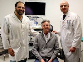 Director of otolaryngology at the University of Alberta Hospital Dr. Hadi Seikaly, left, and head and neck cancer surgeon Dr. Vincent Biron, right, pose with neck and cancer survivor Dan Antoniuk, 59 at the University of Alberta Hospital on Tuesday, January 27, 2015  in Edmonton, AB. Just this month, the hospital received $1 million worth of equipment aimed at improving early detection of throat and neck cancers in patients. TREVOR ROBB/EDMONTON SUN