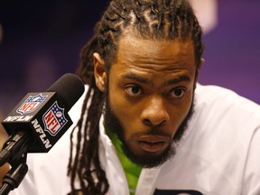 Seahawks cornerback Richard Sherman reacts during media day for Super Bowl XLIX at US Airways Center in Phoenix on Tuesday, Jan. 27, 2015. (Rob Schumacher/Arizona Republic via USA TODAY Sports)