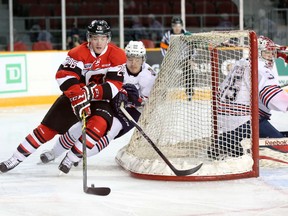 Ottawa 67's forward Trent Mallette fights off Mitchell Vande Sompel of the Oshawa Generals during Tuesday's game at TD Place. (Chris Hofley/Ottawa Sun)