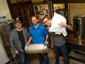Jeff Pastorius, left, Dave Thuss and Aaron Lawrence of the London Brewing Company stand among vats in The Root Cellar in London on Monday. (CRAIG GLOVER, The London Free Press)