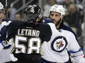 Chris Thorburn #22 of the Winnipeg Jets and Kris Letang #58 of the Pittsburgh Penguins have words in the second period during the game at Consol Energy Center on January 27, 2015 in Pittsburgh, Pennsylvania.
