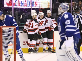 The better Bernier when the Leafs and Devils met on Dec. 4, 2014, was New Jersey's Steve (at centre of celebration), who had a goal and an assist in the Devils' 5-3 victory. (TOM SZCZERBOWSKI/USA Today Sports files)