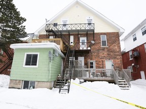 Police tape blocks access to the second-floor fire escape access to an apartment unit at the rear of 862 2nd Ave. W. in Owen Sound on Jan. 23. Police identified apartment resident Lezleigh Hopkins, 28, as the victim of murder. (James Masters/QMI Agency)