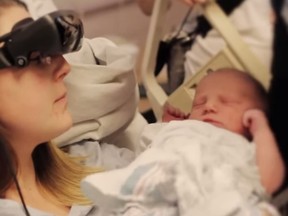 Kathy Beitz of Guelph sees her newborn thanks to special, hi-tech glasses created by Ottawa's eSight in this screengrab from a YouTube video.