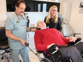 Dental surgeon Larry Soden, and practice manager Janice Buchser move Fraser Perry back in position for an exam during a demonstration of new equipment the Sarnia dental office installed recently to serve patients in wheelchairs, PAUL MORDEN/ THE OBSERVER/ QMI AGENCY