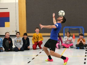 Ottawa Fur​y FC forward Carl Haworth shows off some skill for students at St. Anne Elementary School in Kanata on Tuesday. Haworth, along with teammates Mason Trafford, Nicki Paterson and Tommy Heinemann are touring Ottawa schools with their Pro Futsal Training program, which they started as an off-season side project to teach the indoor soccer game over the winter. (Chris Hofley/Ottawa Sun)