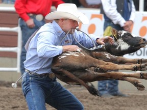 Steve Lloyd of Alix, Alberta, flips his calf in the tie-down roping event at the Calgary Stampede in Calgary, Alberta, on July 15, 2010. The famous Calgary Stampede rodeo awards the highest prize money of any rodeo in the world. MIKE DREW/CALGARY SUN/QMI AGENCY