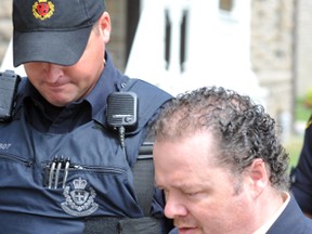 Jerry Hawley, a Prescott man convicted of manslaughter in the starvation death of his brother, Jamie, in 2008, is led to the Brockville, Ont. jail after receiving a 20-year sentence on Friday, August 31, 2013.( Darcy Cheek/Recorder and Times/QMI Agency)