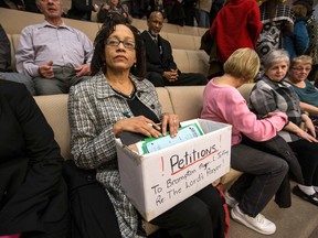 Greta Archer sits with a box of signed petitions wanting the Brampton city council to change their decision on saying the Lord's Prayer before council meetings on Jan. 28, 2015. (Craig Robertson/Toronto Sun)
