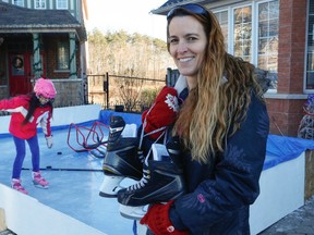 Karen Callery of Ajax, Ont., has her skates and is ready to join her kids on the ice on Wednesday, Jan. 28, 2015, after city council agreed to let her keep her ice rink she built on her front lawn for the rest of the season. (Dave Thomas/QMI Agency)