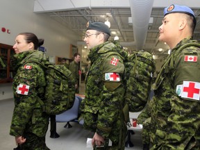 Some of the contingent of 33 Canadian Armed Forces medical personnel assigned to Operation SIRONA in West Africa wait to board a C-150 Airbus at 8 Wing/CFB Trenton,  Ont. early Thursday morning, Jan. 29, 2015.  - JEROME LESSARD/THE INTELLIGENCER/QMI AGENCY