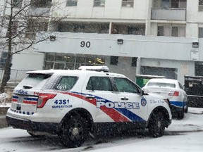 Toronto Police officers remain at a Scarborough apartment building next-door to where a boy, 3, was found walking with a dog​ outside in the cold, with no shoes or coat, over the lunch-hour Thursday. (CHRIS DOUCETTE/Toronto Sun)