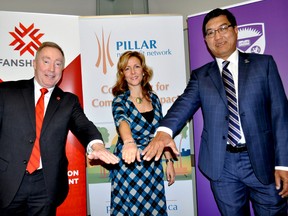 Peter Devlin, president of Fanshawe College, Michelle Baldwin, executive director of Pillar Nonprofit Network, and Amit Chakma, president of Western University, pose for a photo after an announcement in London Ont. Jan. 29, 2015. CHRIS MONTANINI\LONDONER\QMI AGENCY