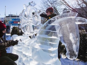 Latvian ice sculptors Karlis Ile (left) and Maija Puncule work on their art at Confederation Park in Ottawa, Winterlude begins Friday. (Errol McGihon/Ottawa Sun/QMI Agency)
