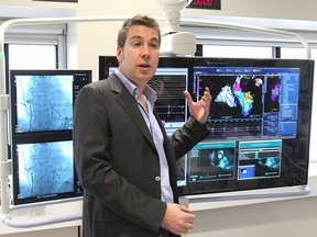 Dr. Damian Redfearn introduces a new cardiac procedure lab to visitors at Kingston General Hospital during its official opening Thursday morning. The image-guidance capabilities of the equipment better allow doctors to see the placement of wires inside the heart when treating rhythm disturbances. (Michael Lea/The Whig-Standard)