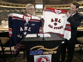 In this 2005 file photo, AHL president and CEO David Andrews and Mark Chipman, chairman of True North, show off the jerseys for the 2006 AHL All-Star game in Winnipeg. (QMI Agency)