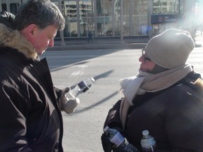 Demonstrators handed out bottles of water at Portage and Main Thursday, Jan. 29, 2015, bearing the words "Bottle water advisory day count: Winnipeg 1 1/2 days, Shoal Lake No. 40, 6,205-plus."