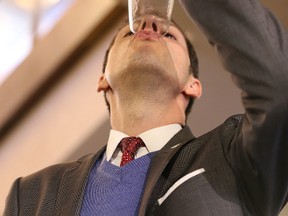 Mayor Brian Bowman throws back a glass of tap water during a press conference at city hall to announce Winnipeg's boil water advisory has been lifted on Thu., Jan. 29, 2015.