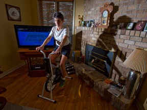 Noralie Jackett rides on a stationary bike as part of her physiotherapy routine in the living room of her home in London. Jackett travelled to Toronto nine weeks ago for a hip replacement after learning the wait time for the surgery in London would be two years. CRAIG GLOVER/The London Free Press/QMI Agency