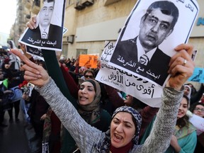 Protesters chant anti-government slogans while holding "Wanted" posters of Egyptian Interior Minister Mohamed Ibrahim during a protest by women at the same location in central Cairo where activist Shaimaa Sabbagh was killed during a protest on Saturday, January 29, 2015, one day before the anniversary of the popular uprising that ousted autocrat Hosni Mubarak in 2011. A group of women protested in Cairo on Thursday against the death of Sabbagh and around 25 other activists allegedly killed by security forces at recent rallies marking the anniversary of Egypt's 2011 uprising. Sabbagh, 32, died on Saturday as riot police were trying to break up a small, peaceful demonstration. Friends said she was shot and images of her bleeding body rippled out across social media, sparking outrage and condemnation.  REUTERS/Mohamed Abd El Ghany