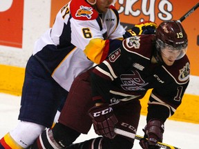 Peterborough Petes' Josh Maguire is dumped to the ice by Erie Otters' Patrick Murphy during first period OHL action at the Memorial Centre on Thursday, Jan. 29, 2015. Clifford Skarstedt/Peterborough Examiner/QMI Agency