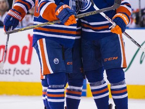 Oscar Klefbom, right, celebrates his goal against the Sabres with Matt Fraser during the first period of Thursday's game at Rexall Place. (Ian Kucerak, Edmonton Sun)