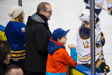 Hockey fans watch the Buffalo Sabres, including forward forward Drew Stafford (21), during the warmup before a NHL hockey game between the Edmonton Oilers and the Buffalo Sabres at Rexall Place in Edmonton, Alta., on Thursday, Jan. 29, 2015. Ian Kucerak/Edmonton Sun/ QMI Agency
