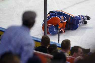 Edmonton defenceman Nikita Nikitin (86) lies on the ice after a hit on the boards during the third period of a NHL hockey game between the Edmonton Oilers and the Buffalo Sabres at Rexall Place in Edmonton, Alta., on Thursday, Jan. 29, 2015. Ian Kucerak/Edmonton Sun/ QMI Agency