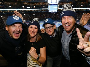 Colin, left, Toronto Sun Editor-in-Chief Wendy Metcalfe, Sun Publisher Mike Power and Justin take in last night's hockey game. (STAN BEHAL/Toronto Sun)