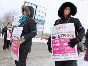 Care coordinators Lesley Kirk, centre, and Sara Tius, right, were among a group of CCAC workers on strike outside of the Erie St. Clair agency's Sarnia office Friday. They're among about 3,000 Ontario Nurses' Association members striking across Ontario. TYLER KULA/ THE OBSERVER/ QMI AGENCY